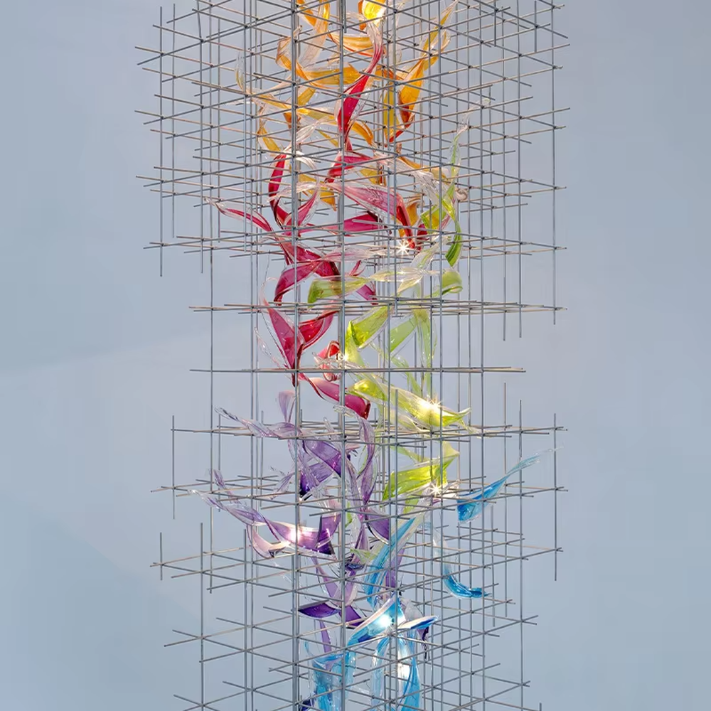 This is a modern artistic metal grid blue transparent decorative chandelier, with a metal grid as the frame, paired with flowing blue transparent shape decorations, and lights dotted in it, creating a dynamic artistic space atmosphere.