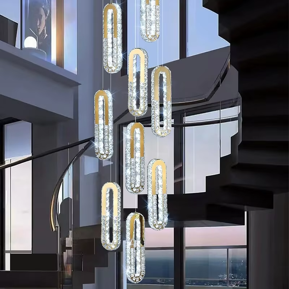 This is a modern luxury multi-layer oval crystal chandelier, with golden borders and transparent crystals hanging in a scattered manner, featuring artistic layers and strong luxury sense. It is used for space lighting and decoration, creating a high-end luxury atmosphere. It is suitable for duplex stairwells, high-ceilinged living rooms, high-end hotel lobbies and other places.
