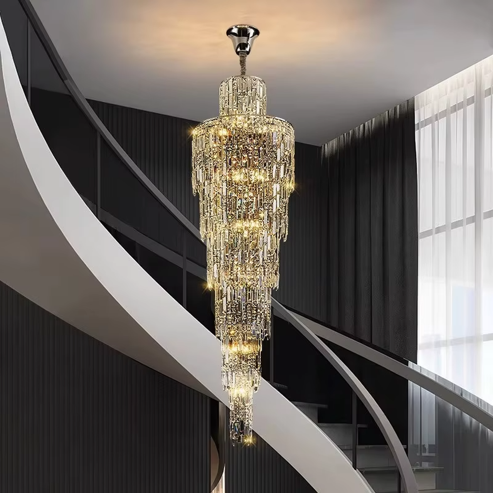 This is a luxury conical multi-layer crystal chandelier, with transparent crystal components hanging in a conical multi-layer shape, brilliant lighting, featuring extremely luxurious sense and visual impact. It is used for space lighting and decoration, creating a high-end luxury atmosphere. It is suitable for duplex stairwells, high-ceilinged living rooms, high-end hotel lobbies and other places.