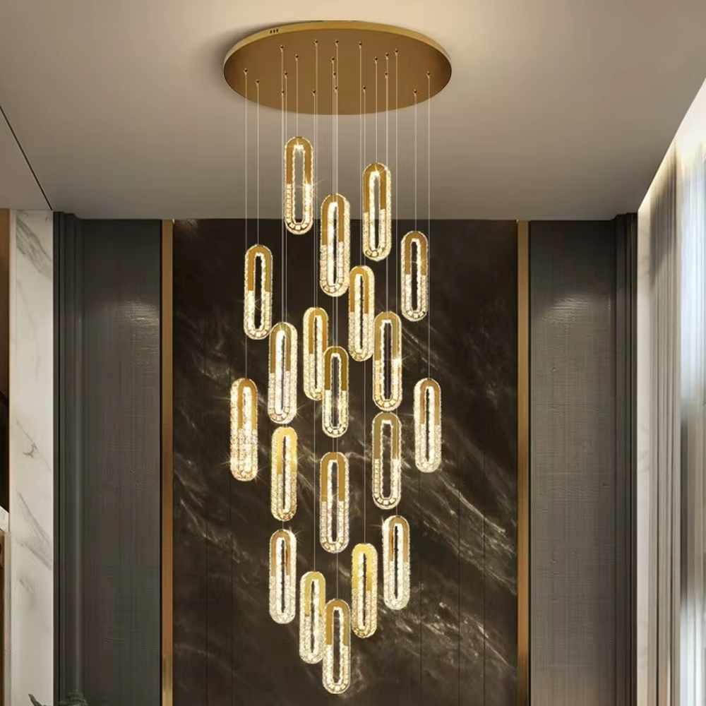 This is a modern luxury multi-layer oval crystal chandelier, with golden borders and transparent crystals hanging in a scattered manner, featuring artistic layers and strong luxury sense. It is used for space lighting and decoration, creating a high-end luxury atmosphere. It is suitable for duplex stairwells, high-ceilinged living rooms, high-end hotel lobbies and other places.