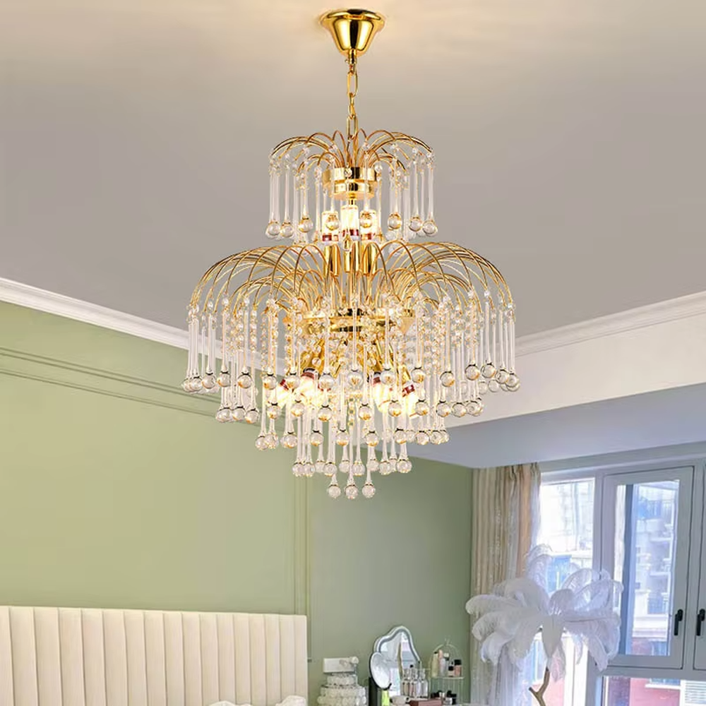 This is a luxurious classical golden multi-layer crystal chandelier, with a golden metal frame paired with numerous transparent crystal pendants. It features a magnificent and grand design, with brilliant lighting. It is used for space lighting and decoration, creating a luxurious and noble atmosphere. Suitable for luxury living rooms, high-end hotel lobbies, villa banquet halls and other places.