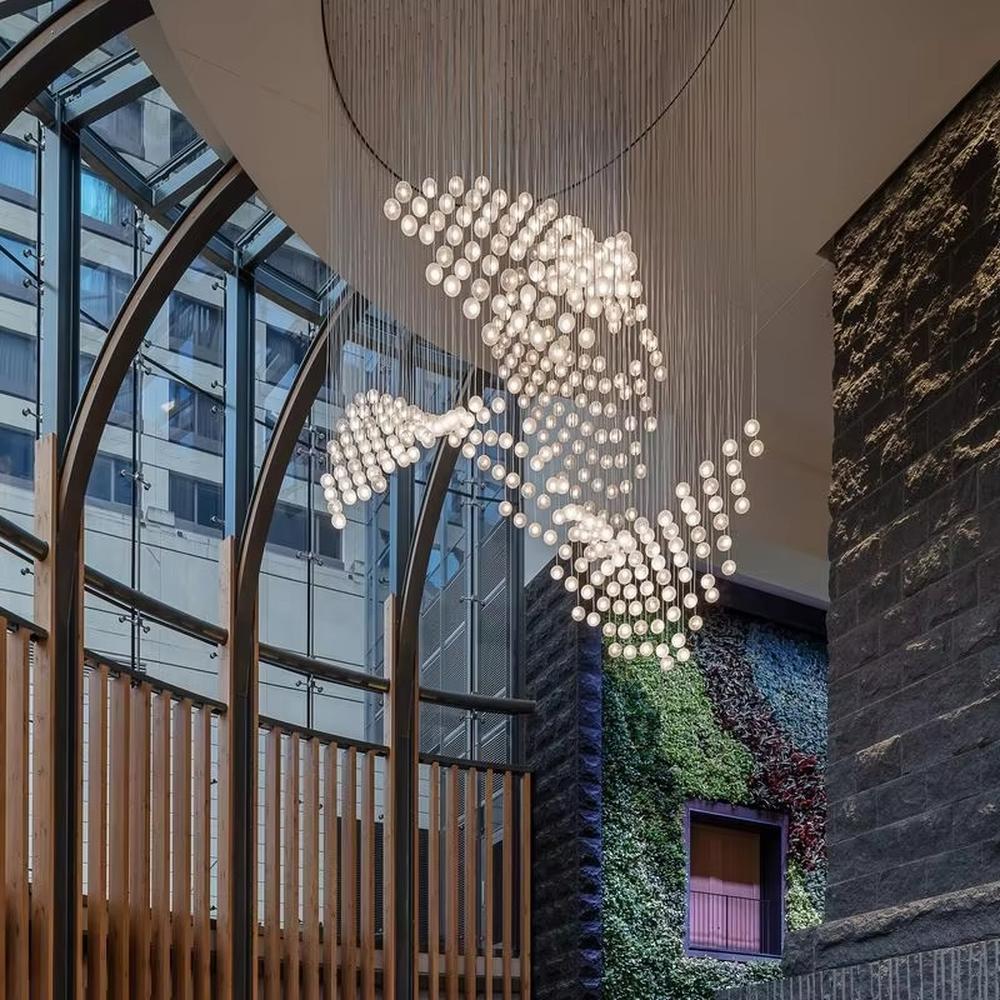 This is a modern artistic spherical light cluster chandelier with numerous white spherical lights arranged in a creative cluster via hanging wires. It features a highly immersive and artistic design with a futuristic ambiance. It is used for space lighting and decoration, creating a stunning visual focus and immersive light-shadow atmosphere. It is suitable for atriums of large commercial complexes, lobbies of high-end hotels, art galleries and exhibition halls and other places.