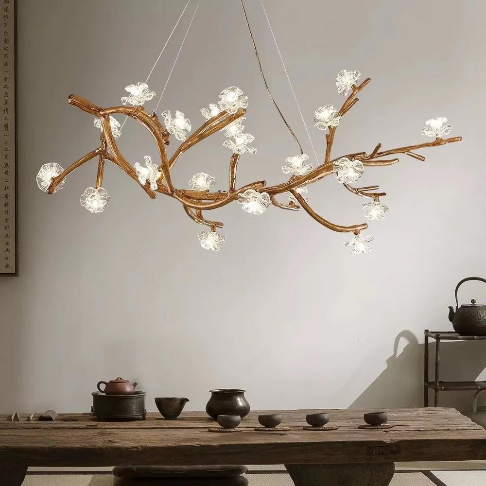 This is a natural artistic branch-shaped chandelier with a golden branch-like frame and multiple spherical lampshades, featuring a natural and flexible design with artistic sense. It is used for space lighting and decoration, creating a natural luxury atmosphere. It is suitable for Nordic-style home living rooms, art homestays, creative studios and other places.