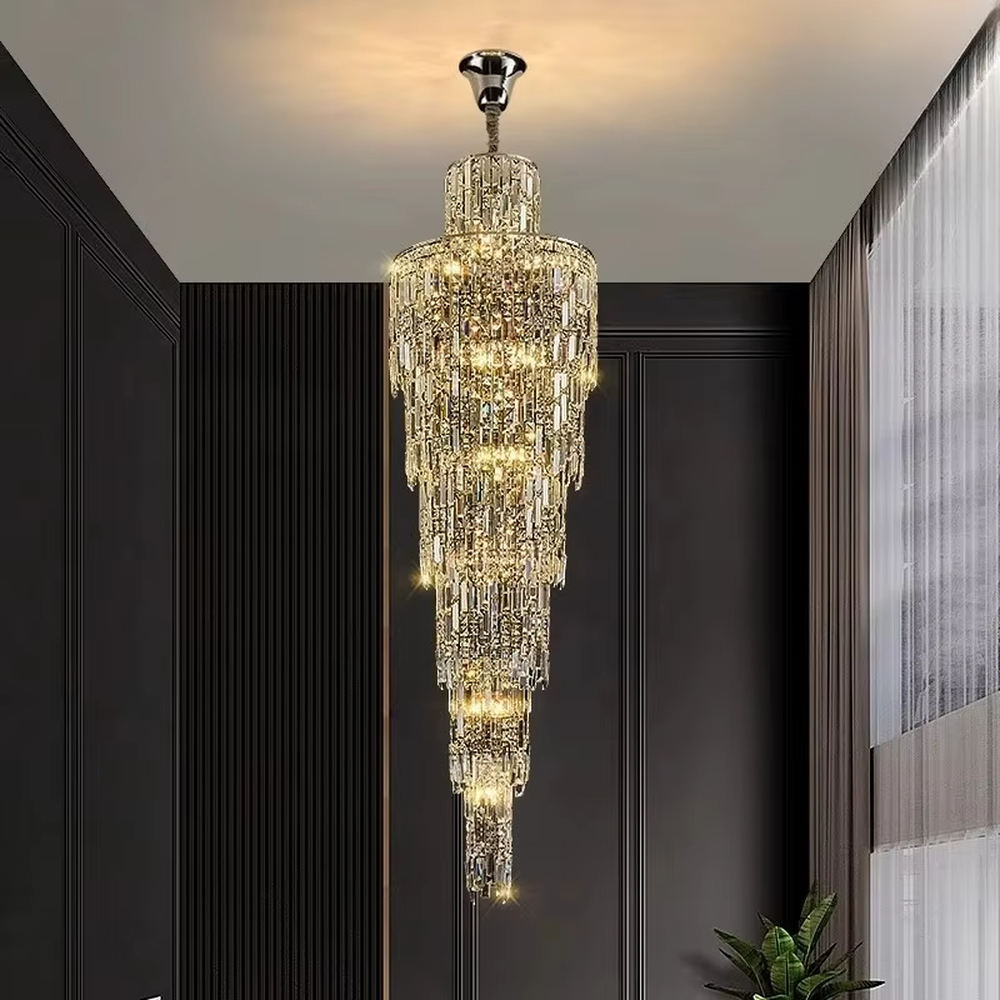 This is a luxury conical multi-layer crystal chandelier, with transparent crystal components hanging in a conical multi-layer shape, brilliant lighting, featuring extremely luxurious sense and visual impact. It is used for space lighting and decoration, creating a high-end luxury atmosphere. It is suitable for duplex stairwells, high-ceilinged living rooms, high-end hotel lobbies and other places.