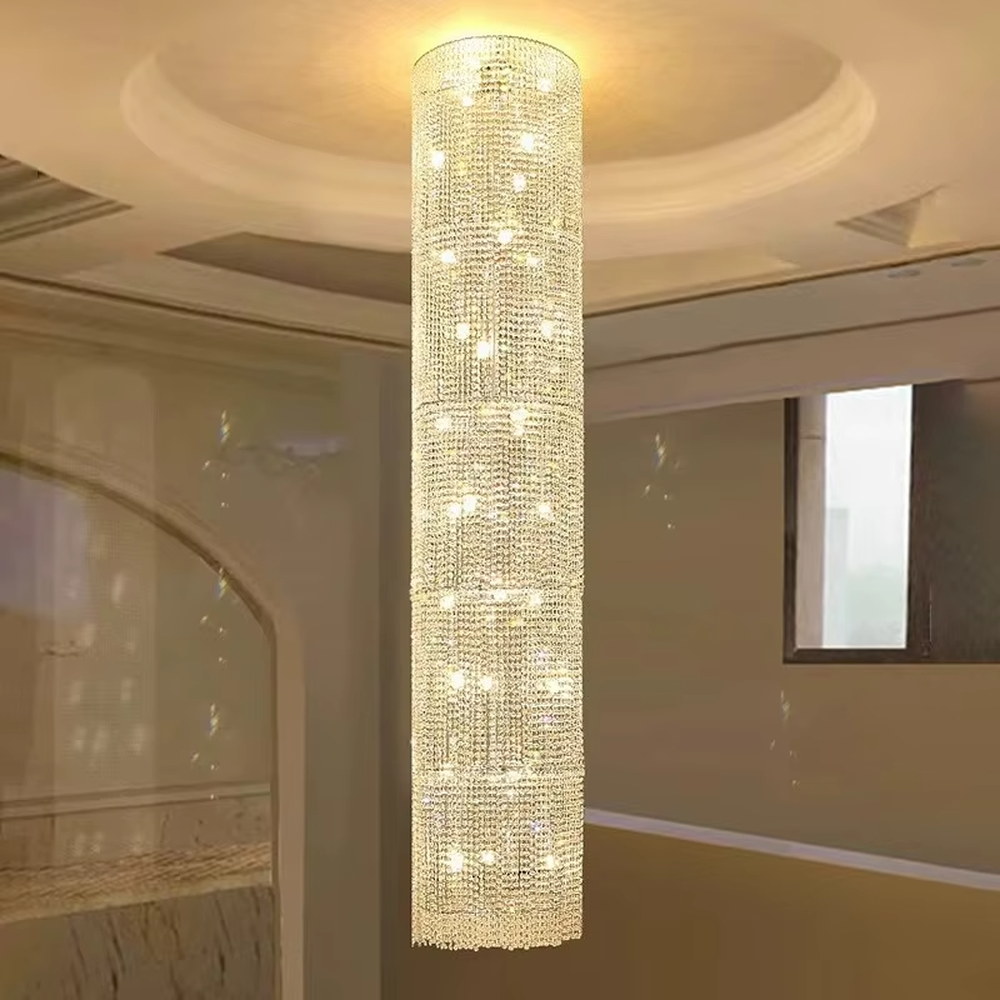This is a luxury cylindrical crystal chandelier, made of full crystal material, with multi-layer crystals forming a cylindrical shape, brilliant lighting, featuring a magnificent and luxurious design with strong visual impact. It is used for space lighting and decoration, creating a high-end luxury atmosphere. It is suitable for high-end hotel lobbies, luxury banquet halls, large commercial exhibition halls and other places.