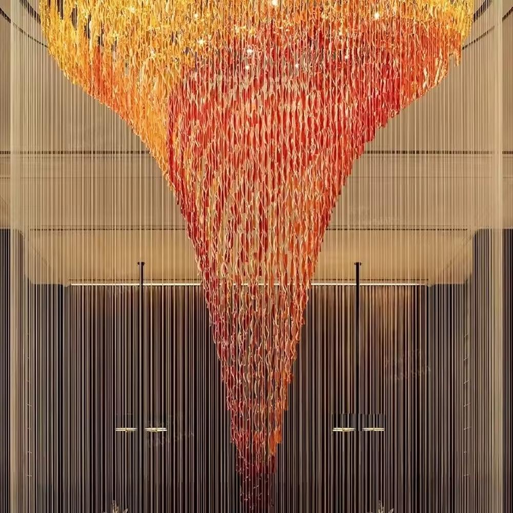 This is a luxurious gradient crystal waterfall-style large chandelier, composed of crystal strings gradient from gold to red in an inverted funnel shape, with a shocking and artistic design. It is used for space lighting and artistic decoration, creating a luxurious and shocking visual atmosphere. It is suitable for high-end hotel lobbies, luxury clubs, atriums of large commercial complexes and other places.