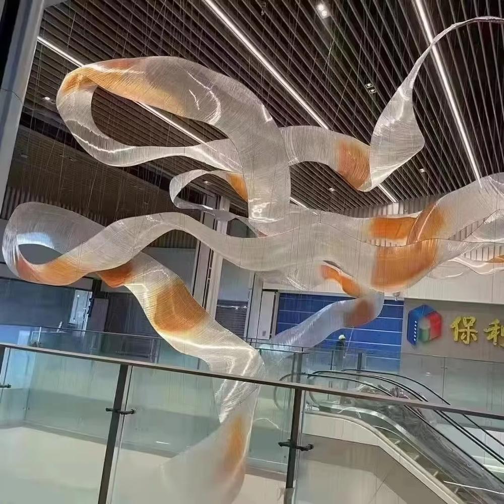 This is an artistic streamline chandelier with a flowing ribbon shape in blue and white gradient, featuring great dynamism and artistry. It is used for space lighting and artistic decoration, significantly enhancing the artistic atmosphere and visual impact of the space. It is suitable for high-end hotel lobbies, art galleries, atriums of large commercial spaces and other places.