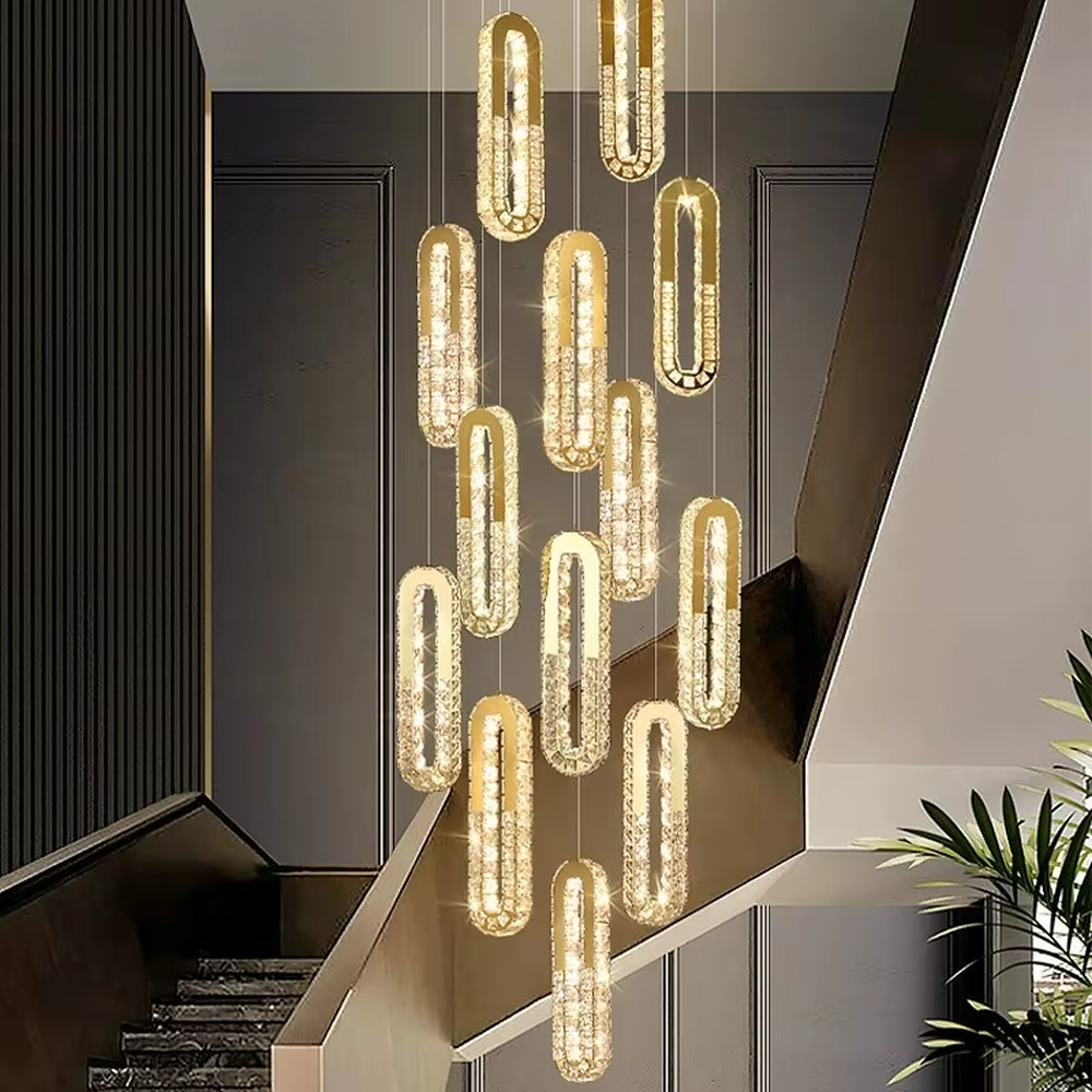 This is a modern luxury multi-layer oval crystal chandelier, with golden borders and transparent crystals hanging in a scattered manner, featuring artistic layers and strong luxury sense. It is used for space lighting and decoration, creating a high-end luxury atmosphere. It is suitable for duplex stairwells, high-ceilinged living rooms, high-end hotel lobbies and other places.