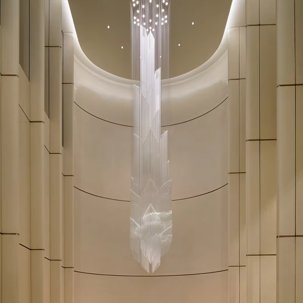 This is a modern artistic large pendant crystal chandelier, composed of numerous transparent crystal strips hanging in layers to form a three-dimensional conical shape. It features soft light refraction, with a strong sense of modern art and spatial depth. It is used for space lighting and artistic decoration, creating a modern artistic and high-end ethereal atmosphere. Suitable for high-ceiling lobbies of high-end hotels, high-ceiling spaces in luxury villas, art exhibition halls and other places.