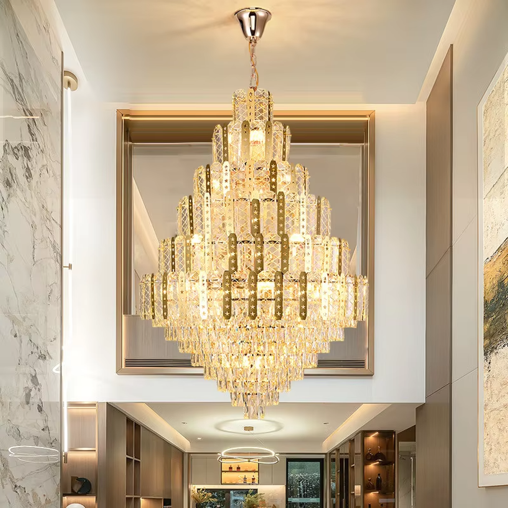This is a luxurious multi-layer crystal frame chandelier, with a golden metal frame paired with transparent crystals in a layered tower shape. When lit, the light is brilliant and gorgeous, creating a high-end luxurious atmosphere.