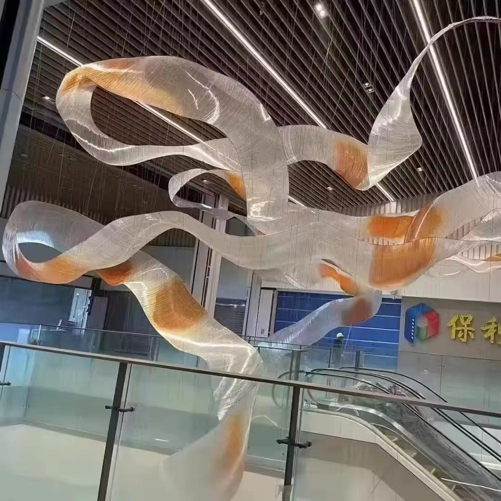 This is an artistic streamline chandelier with a flowing ribbon shape in blue and white gradient, featuring great dynamism and artistry. It is used for space lighting and artistic decoration, significantly enhancing the artistic atmosphere and visual impact of the space. It is suitable for high-end hotel lobbies, art galleries, atriums of large commercial spaces and other places.