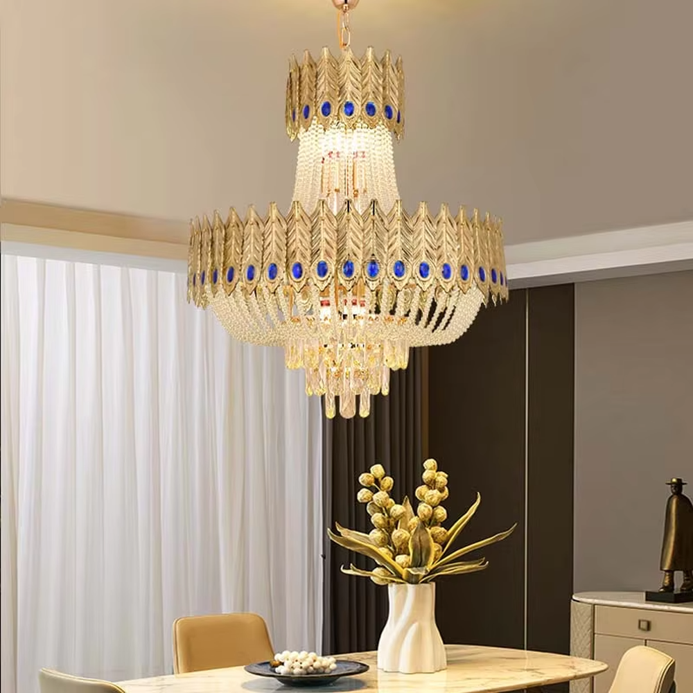 This is a luxurious palace-style double-layer feather gem crystal chandelier, with a golden feather-shaped frame inlaid with blue gem decorations, paired with transparent crystal pendants. The double-layer design is magnificent and grand, with brilliant and elegant lighting, creating a noble and luxurious atmosphere.