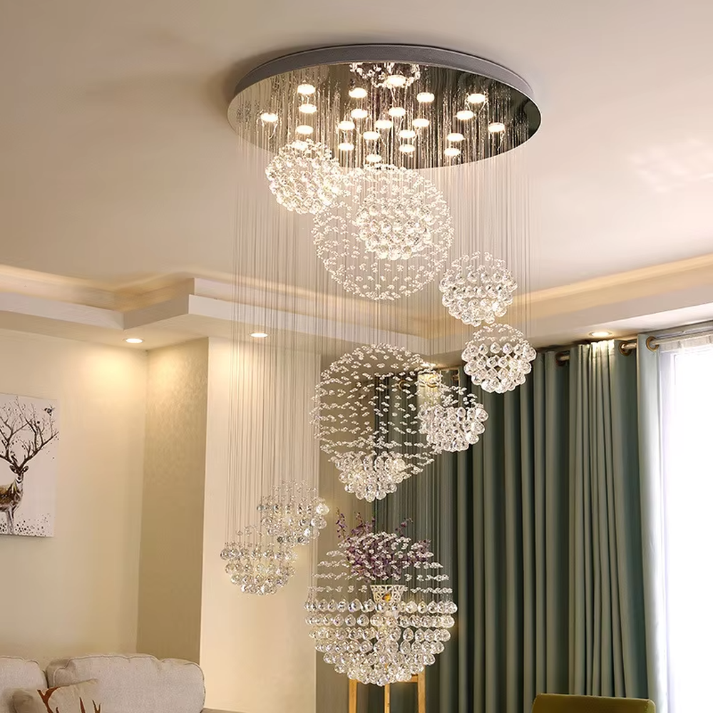 This is a modern luxurious multi-layer spherical crystal chandelier, composed of multiple transparent crystal balls forming spherical structures hung in layers. It features strong artistic sense and spatial decorativeness, with brilliant and grand lighting. It is used for space lighting and artistic decoration, creating a luxurious and high-end atmosphere. Suitable for high-ceiling lobbies of high-end hotels, double-height living rooms in luxury villas, large art exhibition halls and other places.