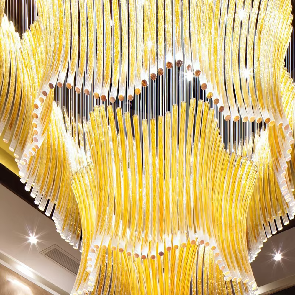 This is a luxurious artistic multi-layer yellow glass tube chandelier, composed of numerous yellow glass tubes arranged in layers to form a flowing three-dimensional shape. It features brilliant and layered lighting, with a strong sense of artistic tension and luxury. It is used for space lighting and artistic decoration, creating a luxurious artistic and grand atmosphere. Suitable for high-end hotel lobbies, luxury banquet halls, art clubs and other places.