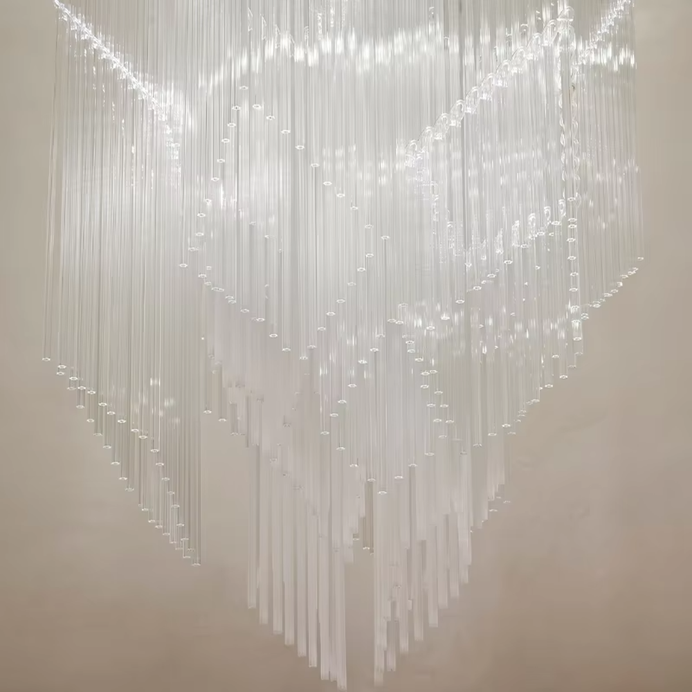 This is a modern artistic large pendant crystal chandelier, composed of numerous transparent crystal strips hanging in layers to form a three-dimensional conical shape. It features soft light refraction, with a strong sense of modern art and spatial depth. It is used for space lighting and artistic decoration, creating a modern artistic and high-end ethereal atmosphere. Suitable for high-ceiling lobbies of high-end hotels, high-ceiling spaces in luxury villas, art exhibition halls and other places.