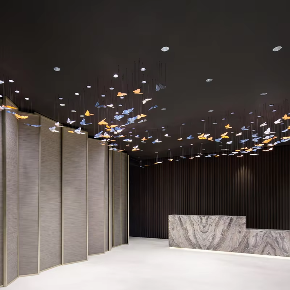 This is an artistic and childlike colorful butterfly-shaped chandelier, with butterfly leaves in various colors (orange, white, blue-gray, etc.) hanging in a scattered manner, featuring strong artistic sense and childlike charm, like a group of butterflies dancing under the light. It is used for space lighting and artistic decoration, creating a lively and artistic atmosphere. Suitable for children's parks, theme restaurants, art exhibition halls and other places.