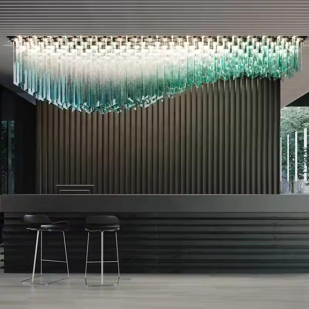 This is a modern artistic gradient crystal chandelier with layered blue-green gradient crystal strips, featuring strong visual impact and modern sense. It is used for space lighting and decoration, creating a high-end luxurious atmosphere. It is suitable for high-end hotel lobbies, commercial exhibition halls, luxury clubs and other places.