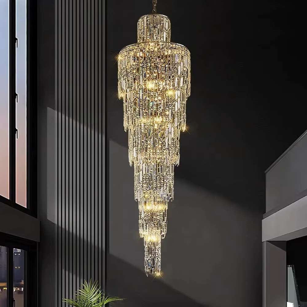 This is a luxury conical multi-layer crystal chandelier, with transparent crystal components hanging in a conical multi-layer shape, brilliant lighting, featuring extremely luxurious sense and visual impact. It is used for space lighting and decoration, creating a high-end luxury atmosphere. It is suitable for duplex stairwells, high-ceilinged living rooms, high-end hotel lobbies and other places.