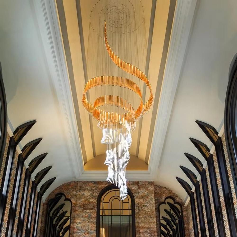This is an artistic gradient spiral-shaped large chandelier, composed of strip elements gradient from gold to white in a spiral structure, featuring a strong artistic sense and visual impact. It is used for space lighting and artistic decoration, creating a luxurious artistic atmosphere. It is suitable for high-end hotel lobbies, art exhibition halls, double-height areas of luxury villas and other places.