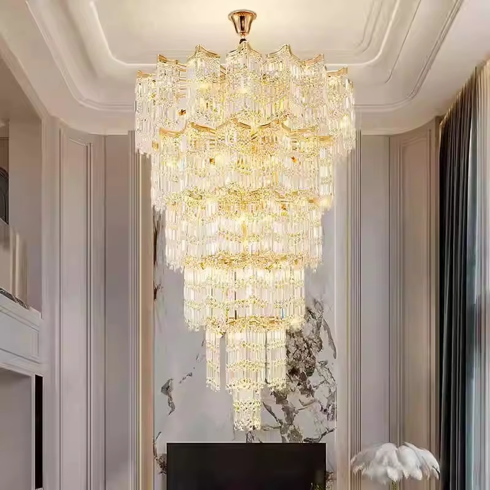 This is a luxury multi-layer conical crystal chandelier, with a golden metal frame and numerous transparent crystal pendants, featuring a magnificent and grand design with brilliant lighting and strong visual impact. It is used for space lighting and decoration, creating a high-end luxury atmosphere. It is suitable for duplex stairwells, high-ceilinged living rooms, high-end hotel lobbies, luxury villas and other places.