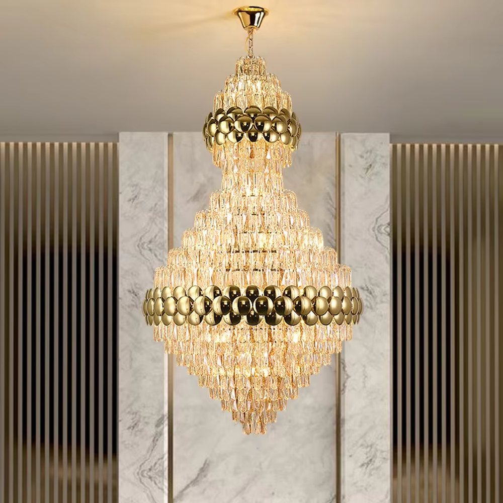 This is a luxurious double-layer crystal golden ball chandelier, featuring a golden metal frame paired with transparent crystals and golden spherical decorations, with a double-layer hierarchical design. It has a magnificent and grand style, with brilliant and soft lighting, creating a high-end luxurious atmosphere.