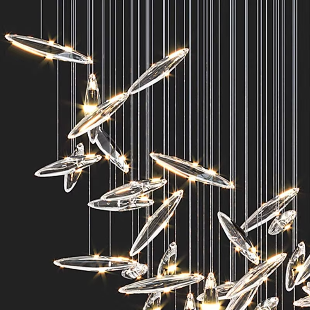 This is a modern artistic fish school-shaped hanging chandelier, featuring multiple silver fish-shaped decorations (crystal/metal texture) suspended by thin wires. The design is dynamic, modern and full of artistic tension, with brilliant and exquisite lighting. It is used for space lighting and artistic decoration, creating a high-end modern artistic atmosphere. Suitable for high-ceiling areas of high-end hotels, luxury commercial clubs, modern art villas and other places.