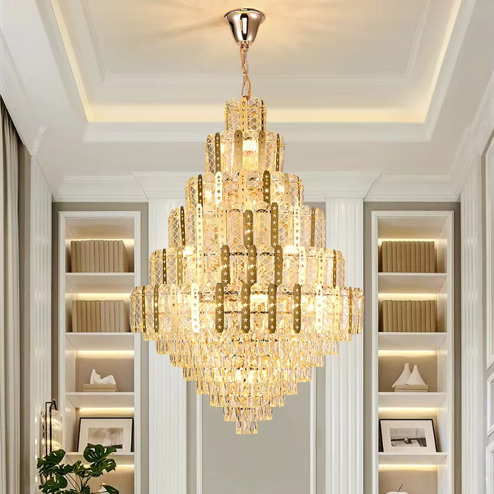 This is a luxurious multi-layer crystal frame chandelier, with a golden metal frame paired with transparent crystals in a layered tower shape. When lit, the light is brilliant and gorgeous, creating a high-end luxurious atmosphere.