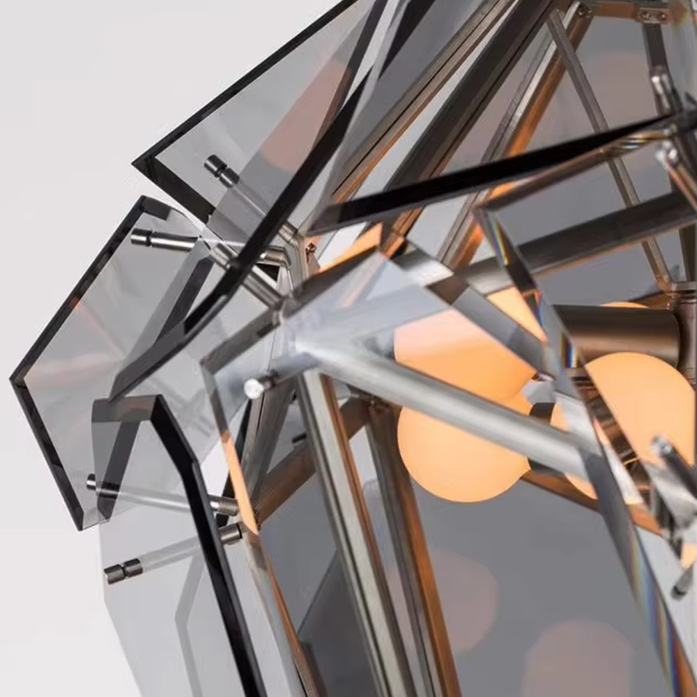 This is a modern luxurious diamond ice crystal-shaped chandelier (including transparent/smoke gray two colors), with a golden metal frame paired with geometric cut transparent/smoke gray material. The shape is like ice crystal diamond, and the lighting is brilliant and high-end, creating a high-end artistic atmosphere.