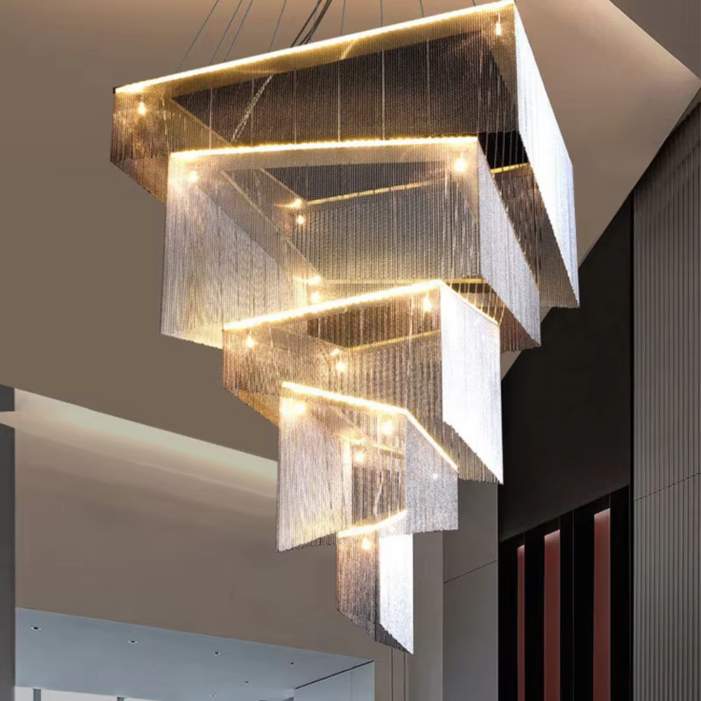 This is a modern artistic multi-layer square metal chain chandelier, composed of multi-layer square structures, paired with metal chains and LED light strips. It features soft and layered lighting, with a strong sense of modernity and spatial tension. It is used for space lighting and artistic decoration, creating a modern artistic and high-end atmosphere. Suitable for high-end hotel lobbies, art exhibition halls, high-ceiling spaces in luxury villas and other places.