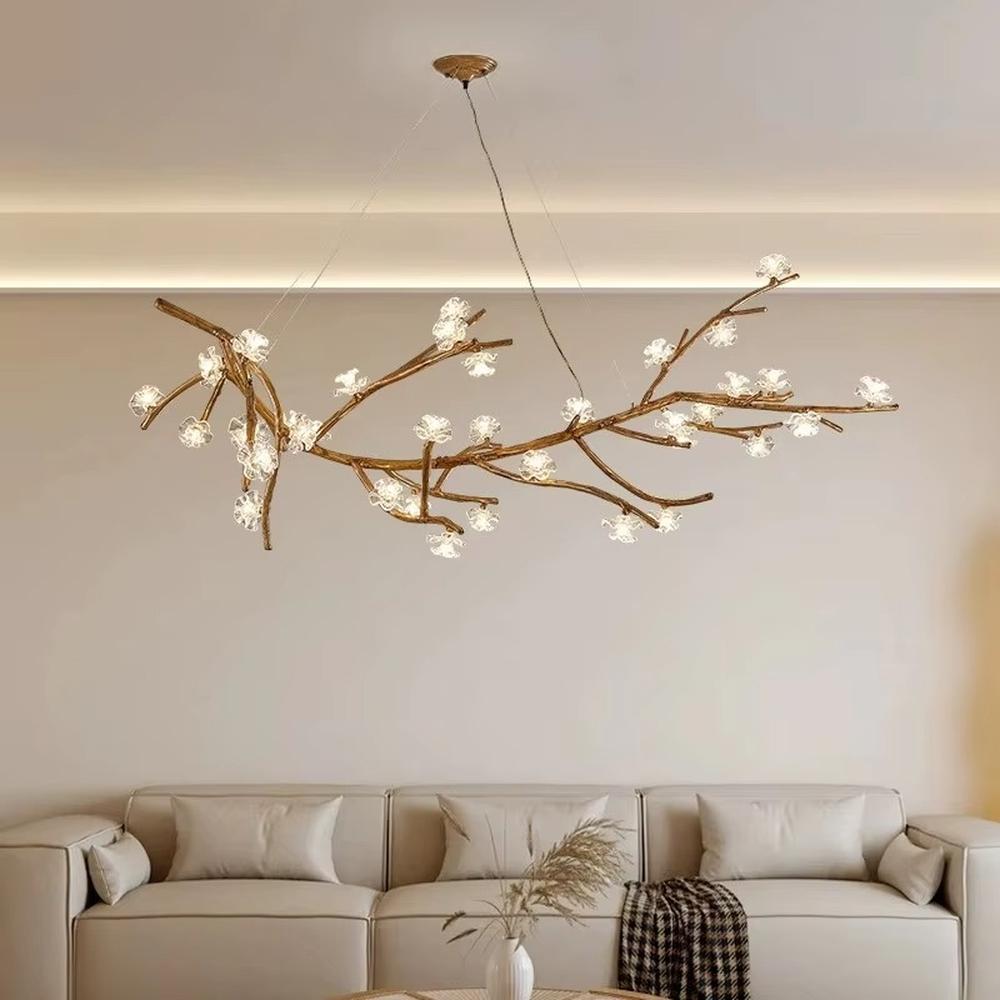 This is a natural artistic branch-shaped chandelier with a golden branch-like frame and multiple spherical lampshades, featuring a natural and flexible design with artistic sense. It is used for space lighting and decoration, creating a natural luxury atmosphere. It is suitable for Nordic-style home living rooms, art homestays, creative studios and other places.