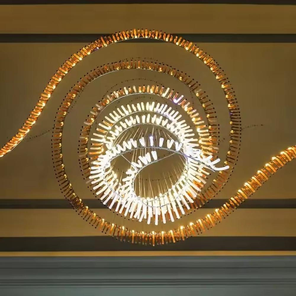 This is an artistic gradient spiral-shaped large chandelier, composed of strip elements gradient from gold to white in a spiral structure, featuring a strong artistic sense and visual impact. It is used for space lighting and artistic decoration, creating a luxurious artistic atmosphere. It is suitable for high-end hotel lobbies, art exhibition halls, double-height areas of luxury villas and other places.