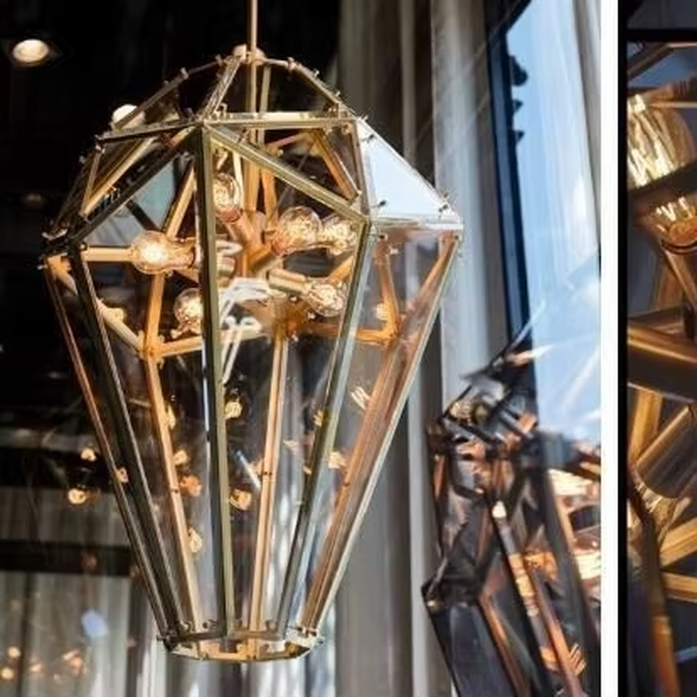 This is a modern luxurious diamond ice crystal-shaped chandelier (including transparent/smoke gray two colors), with a golden metal frame paired with geometric cut transparent/smoke gray material. The shape is like ice crystal diamond, and the lighting is brilliant and high-end, creating a high-end artistic atmosphere.