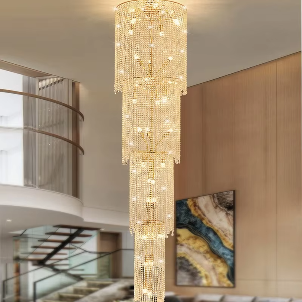 This is a luxury multi-layer cylindrical crystal chandelier, with a golden metal frame and multi-layer transparent crystal pendants, brilliant lighting, featuring a magnificent and grand design with strong visual impact. It is used for space lighting and decoration, creating a high-end luxury atmosphere. It is suitable for duplex stairwells, high-ceilinged living rooms, high-end hotel lobbies and other places.