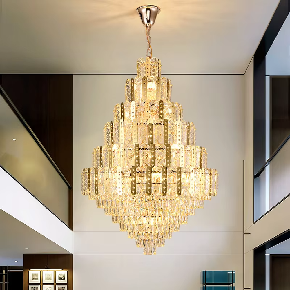 This is a luxurious multi-layer crystal frame chandelier, with a golden metal frame paired with transparent crystals in a layered tower shape. When lit, the light is brilliant and gorgeous, creating a high-end luxurious atmosphere.