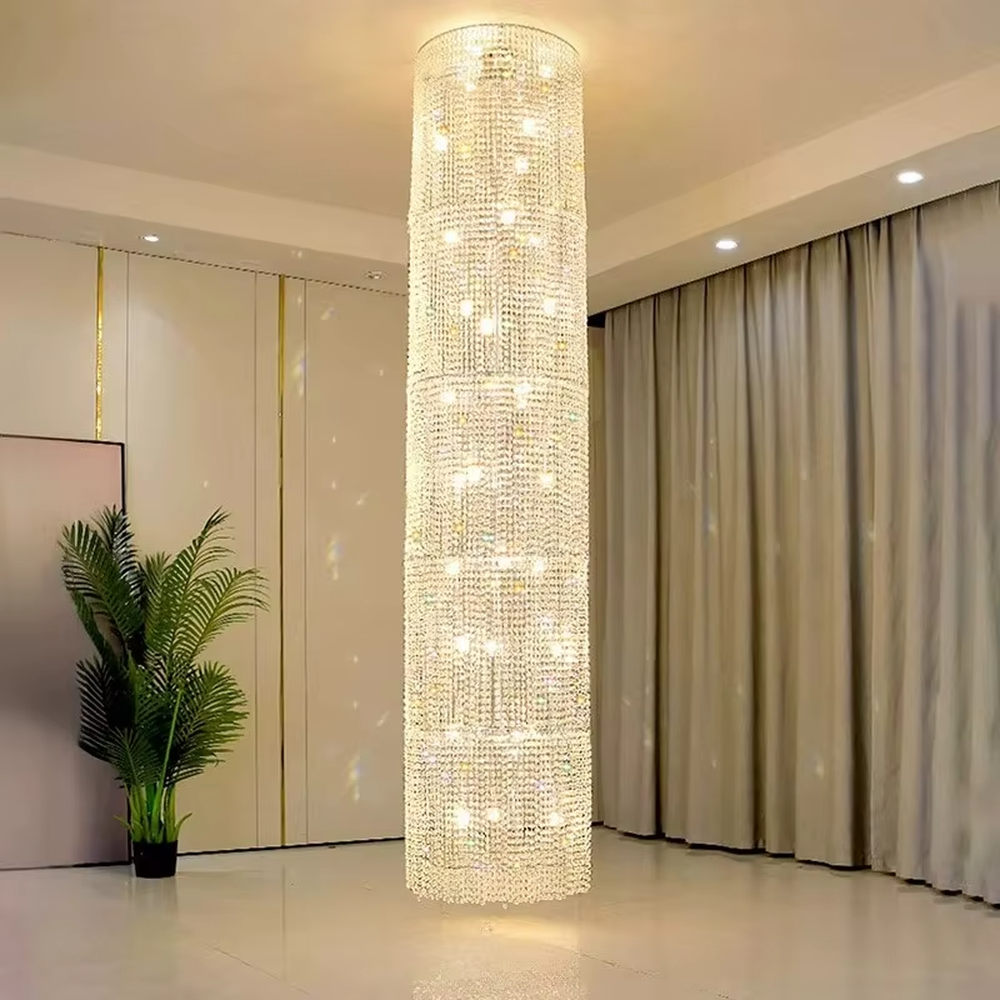 This is a luxury cylindrical crystal chandelier, made of full crystal material, with multi-layer crystals forming a cylindrical shape, brilliant lighting, featuring a magnificent and luxurious design with strong visual impact. It is used for space lighting and decoration, creating a high-end luxury atmosphere. It is suitable for high-end hotel lobbies, luxury banquet halls, large commercial exhibition halls and other places.