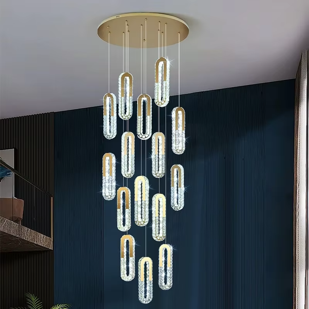 This is a modern luxury multi-layer oval crystal chandelier, with golden borders and transparent crystals hanging in a scattered manner, featuring artistic layers and strong luxury sense. It is used for space lighting and decoration, creating a high-end luxury atmosphere. It is suitable for duplex stairwells, high-ceilinged living rooms, high-end hotel lobbies and other places.