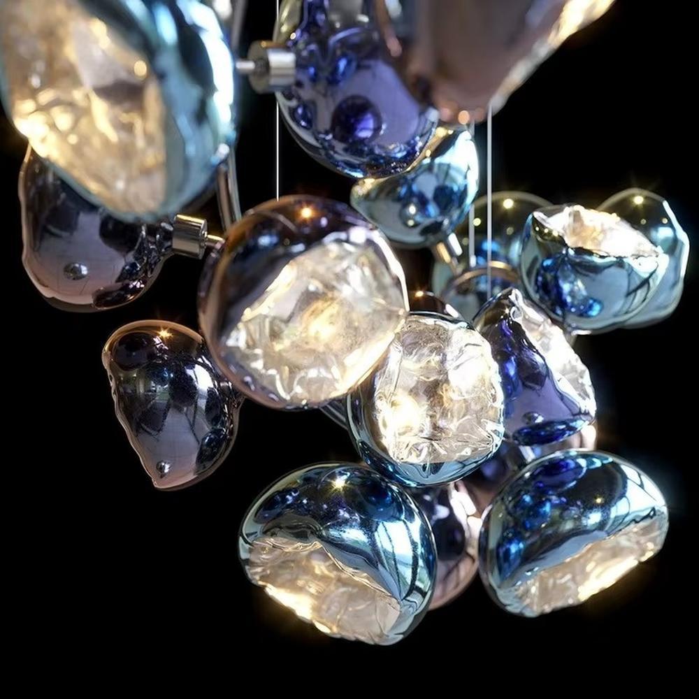 This is an artistic gem-shaped chandelier with blue-black metallic gem-like lampshades distributed in a branch-like structure, featuring a modern artistic design with strong luxury sense. It is used for space lighting and decoration, creating a modern artistic luxury atmosphere. It is suitable for modern luxury home living rooms, high-end commercial exhibition halls, art soft decoration spaces and other places.
