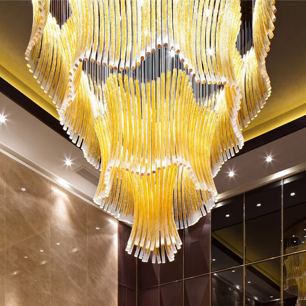 This is a luxurious artistic multi-layer yellow glass tube chandelier, composed of numerous yellow glass tubes arranged in layers to form a flowing three-dimensional shape. It features brilliant and layered lighting, with a strong sense of artistic tension and luxury. It is used for space lighting and artistic decoration, creating a luxurious artistic and grand atmosphere. Suitable for high-end hotel lobbies, luxury banquet halls, art clubs and other places.