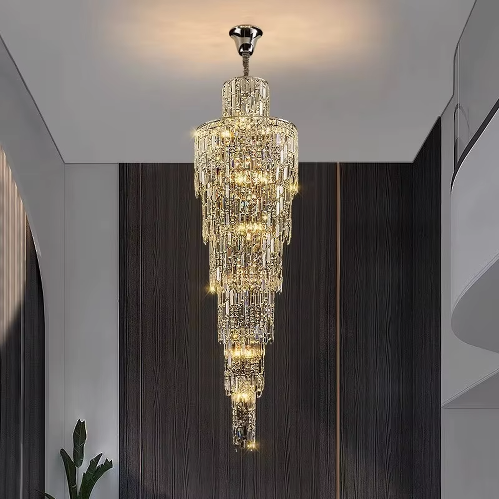 This is a luxury conical multi-layer crystal chandelier, with transparent crystal components hanging in a conical multi-layer shape, brilliant lighting, featuring extremely luxurious sense and visual impact. It is used for space lighting and decoration, creating a high-end luxury atmosphere. It is suitable for duplex stairwells, high-ceilinged living rooms, high-end hotel lobbies and other places.