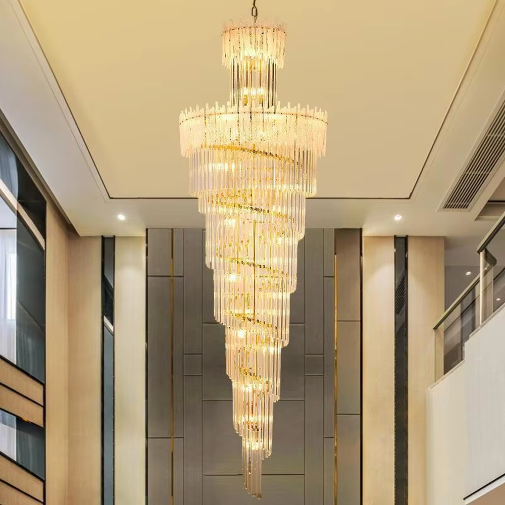 This is a modern luxurious large spiral crystal chandelier, with a golden metal frame paired with transparent crystal strips arranged in multiple spirals. It features a strong sense of spatial depth and artistry, with brilliant and grand lighting. It is used for space lighting and artistic decoration, creating a luxurious and high-end atmosphere. Suitable for high-ceiling lobbies of high-end hotels, double-height living rooms in luxury villas, large commercial clubs and other places.