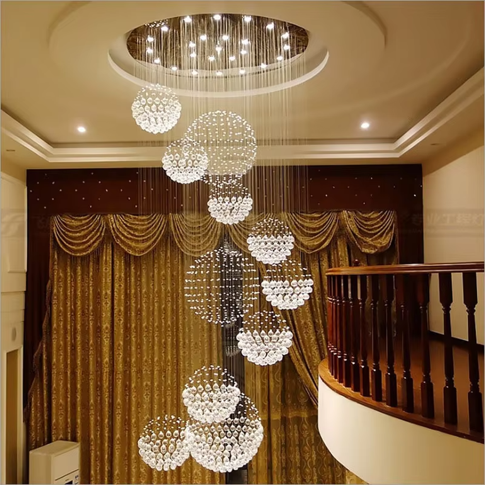 This is a modern luxurious multi-layer spherical crystal chandelier, composed of multiple transparent crystal balls forming spherical structures hung in layers. It features strong artistic sense and spatial decorativeness, with brilliant and grand lighting. It is used for space lighting and artistic decoration, creating a luxurious and high-end atmosphere. Suitable for high-ceiling lobbies of high-end hotels, double-height living rooms in luxury villas, large art exhibition halls and other places.