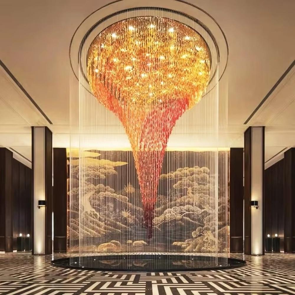 This is a luxurious gradient crystal waterfall-style large chandelier, composed of crystal strings gradient from gold to red in an inverted funnel shape, with a shocking and artistic design. It is used for space lighting and artistic decoration, creating a luxurious and shocking visual atmosphere. It is suitable for high-end hotel lobbies, luxury clubs, atriums of large commercial complexes and other places.