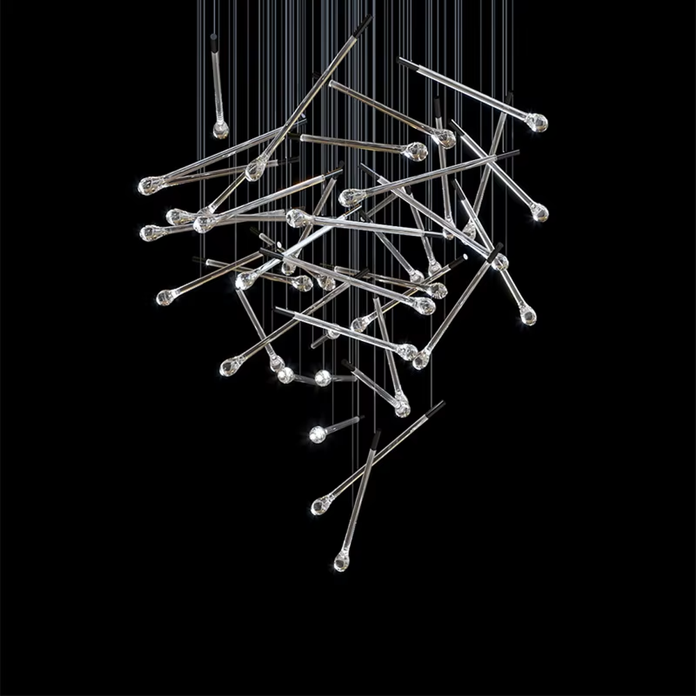 This is a modern artistic transparent crystal rod staggered hanging chandelier, with silver metal slender rods paired with crystal ends, multiple rods staggered and hung. When the lights are on, it is brilliant and dreamy, creating a highly artistic space atmosphere.