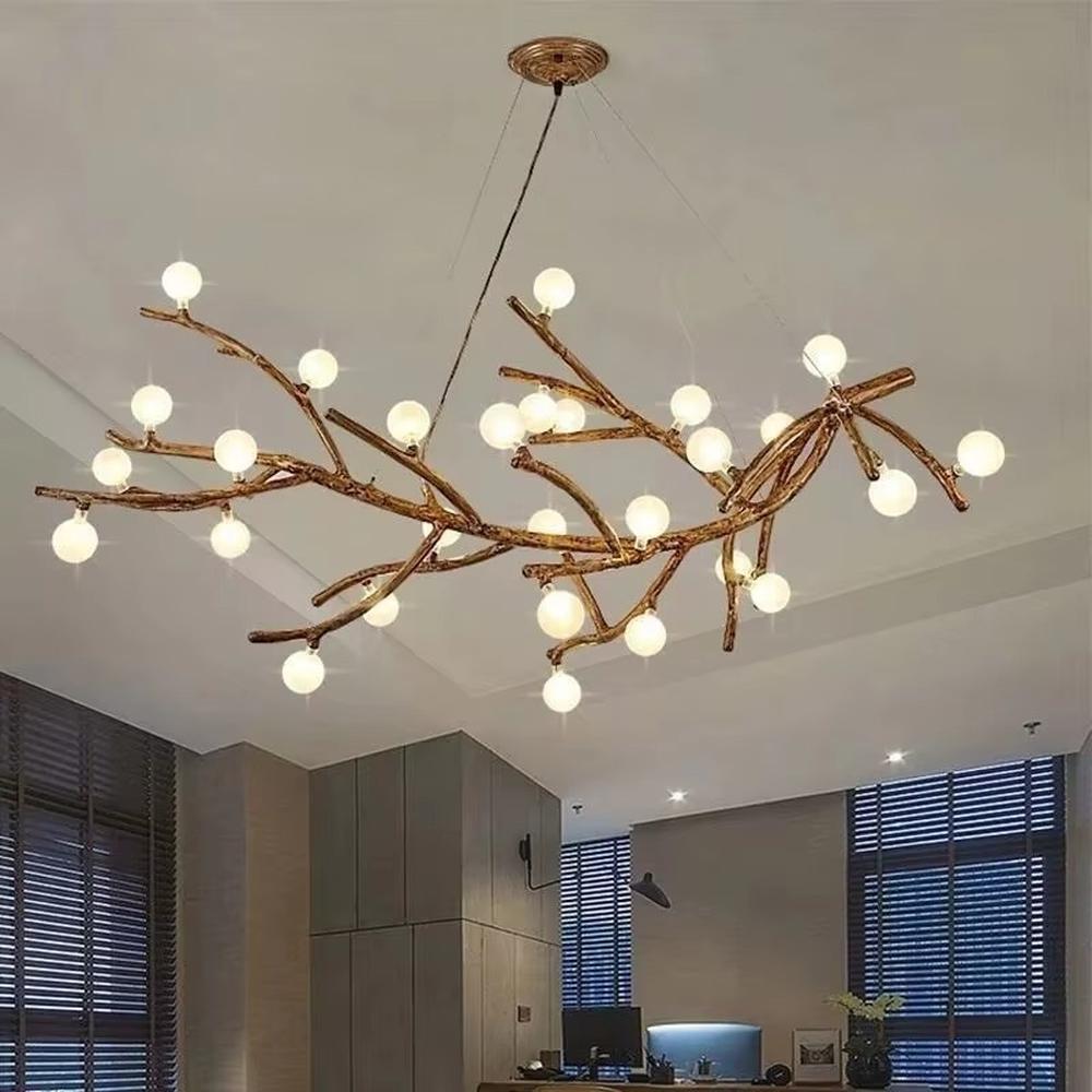 This is a natural artistic branch-shaped chandelier with a golden branch-like frame and multiple spherical lampshades, featuring a natural and flexible design with artistic sense. It is used for space lighting and decoration, creating a natural luxury atmosphere. It is suitable for Nordic-style home living rooms, art homestays, creative studios and other places.