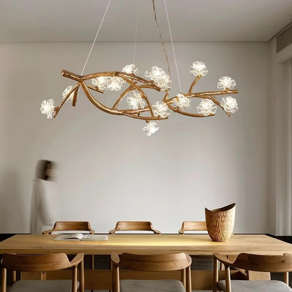 This is a natural artistic branch-shaped chandelier with a golden branch-like frame and multiple spherical lampshades, featuring a natural and flexible design with artistic sense. It is used for space lighting and decoration, creating a natural luxury atmosphere. It is suitable for Nordic-style home living rooms, art homestays, creative studios and other places.