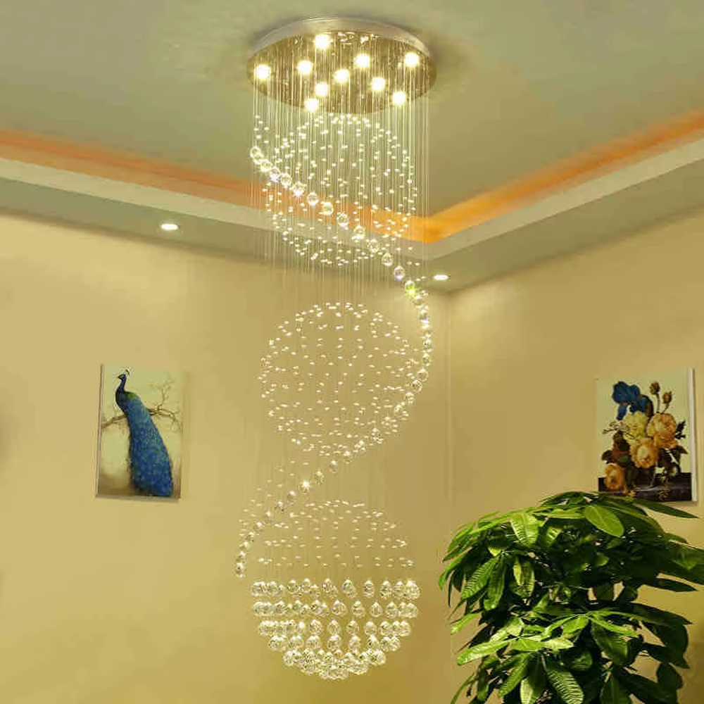 Modern art spiral spherical crystal high-ceiling chandelier, warm light effect, creating a luxurious and dynamic space atmosphere.