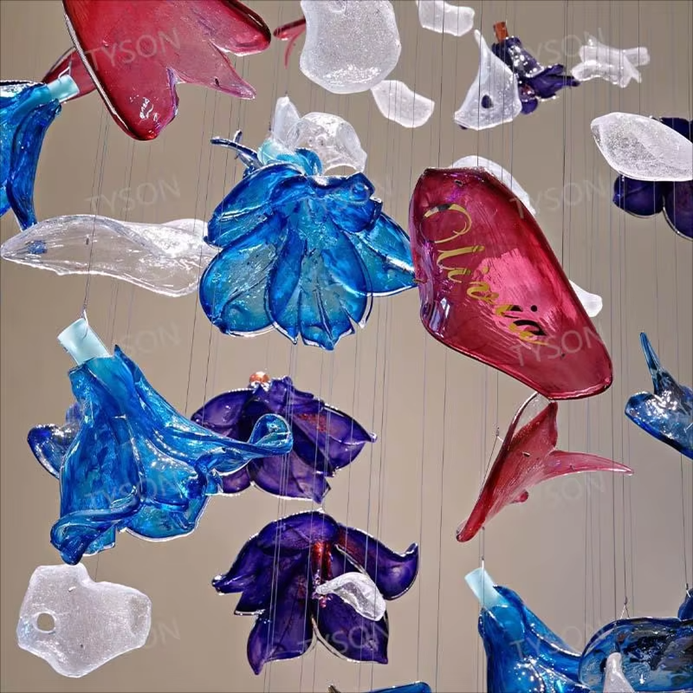 Art Firework Colored Glass Chandelier (blue-purple-red transparent glass petals + radial metal wire frame), warm and cool light effect, creating a bright and dreamy high-end space atmosphere.
