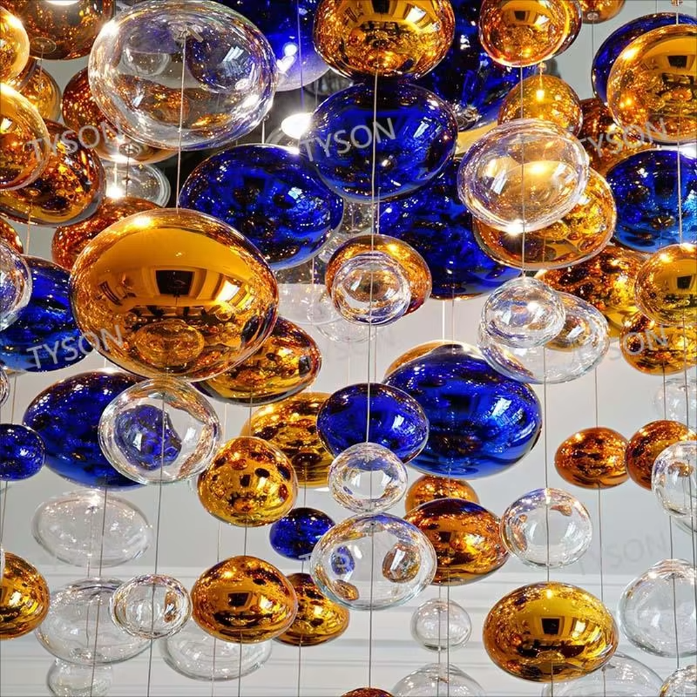 Art colorful glass ball suspension chandelier (gold/blue/transparent combination), warm light effect, creating a dreamy and brilliant luxurious space atmosphere.