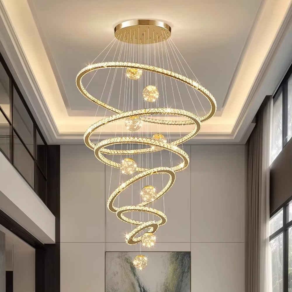Modern top-luxury spiral ring crystal high-ceiling chandelier, golden frame + full crystal ring inlay + crystal light ball decoration + warm light effect, creating a luxurious artistic atmosphere in high-ceiling spaces.