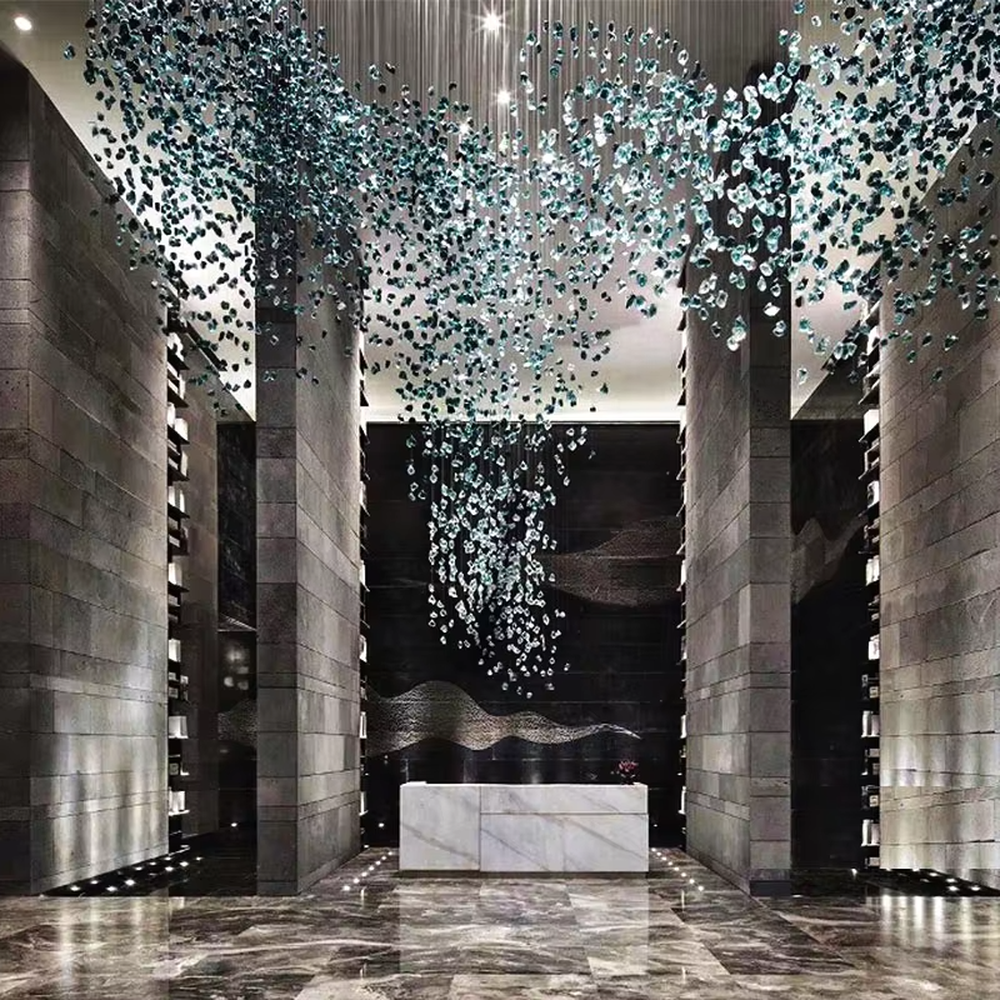 This large-scale art crystal chandelier features a dome pendant shape made of blue-white gradient crystal clusters, like blooming flower clusters or deep-sea ripples. It serves both lighting and artistic decorative purposes, ideal for high-ceiling commercial spaces such as hotel lobbies, sales offices, and high-end clubs.